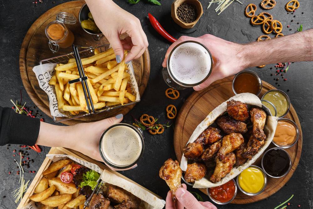 Townville 103 restaurant guests enjoying wings, fries, and beer together at indoor or outdoor dining in downtown Seneca SC.